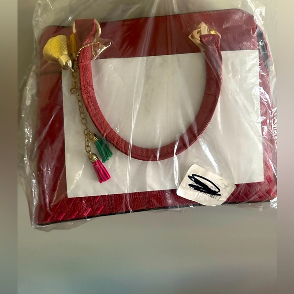 Handbags - NWT in packaging still leather handbag with strap and many compartments